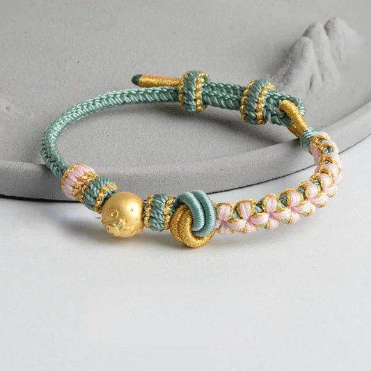 Indulge in the luxurious charm of the Colorful Handwoven Peach Blossom Concentric Knot Eight Strand Braid Beaded Cord Couple Bracelet. Made with high-quality metal and a zinc alloy, this bracelet exudes elegance and sophistication. Embrace the latest fashion trends with this exquisitely crafted piece, adorned with a charming concentric knot and intricate beadwork. Perfect for sophisticated women who appreciate art and style.